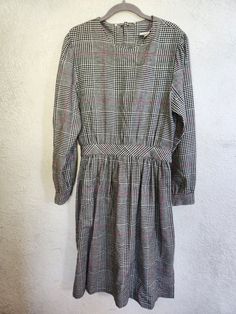 Vintage 90's Lanz cotton plaid dress. Dress features back button closures from the neck to the waist, as well as buttons at the sleeve cuffs. Attached "belt" at the waist with 2 button options for a cinched waist. 100% cotton. All photos should be considered part of the description.  Measurements are approximate: Bust: 20"  Waist: 16.5" Sleeves from shoulder hem: 24" Length: 42.5" Vintage Plaid Dress For Fall, Spring Plaid Long Sleeve Dress For Work, Spring Long Sleeve Plaid Work Dress, Long Sleeve Plaid Dress For Daywear, Spring Long Sleeve Plaid Dress For Work, Plaid Long Sleeve Dress For Daywear, Vintage Plaid Workwear Dress, Vintage Belted Dress For Fall, Vintage Belted Dresses For Fall