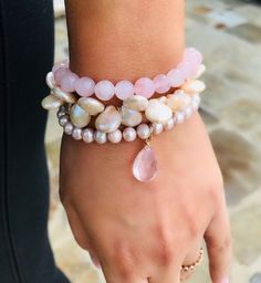 Feminine and so beautiful on the arm, this cluster of three pink pearl and quartz bracelets just become a classic and a favorite from the moment you put them on. Traditional and yet so on trend this season, from the stunning smooth round pearls to the lustrous coin pearls, and down to the gorgeous large pink quartz drop, this is truly the pearl lovers arm candy. I've heard it said that pink is the new black and what could be more true of this piece that will go with practically everything you wear. Try wearing them separately or layer with other bracelets! What a beautiful gift for any occasion!! Adjustable Pink Pearl Bracelet With Pearl Drop, Pink Pearl Drop Bracelet For Wedding, Pink Pearl Bracelet With Pearl Drop, Pink Pearl Drop Bracelet As Gift, Pink Pearl Bracelet Gift, Elegant Pink Pearl Beaded Bracelets, Feminine Pink Pearl Bracelet For Gift, Elegant Pink Pearl Bracelet As A Gift, Pink Pearl Drop Bracelet