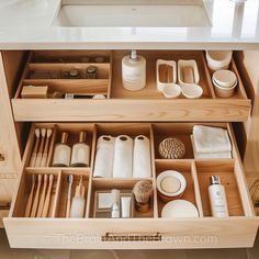 an organized drawer in a kitchen with dishes and utensils