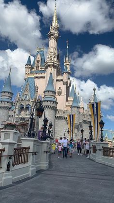 people are walking around in front of the castle