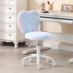 a white desk chair with a blue and pink heart shaped seat cushion on it's back