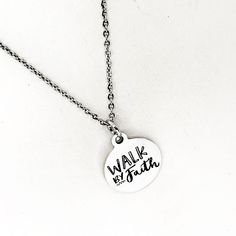 This silver necklace is a simple but beautiful gift for a loved one in your life. It is a stainless steel laser engraved charm on a stainless steel link chain. The charm has the following on it: Walk by Faith This necklace is available on a chain in your choice of 16, 18, 20, 22, 24, 26, 28 or 30 iInches. The pendant is also available for separate purchase if you have another necklace on which you would like to wear it. Each item comes individually boxed and ready to give as a gift. This jewelry Inspirational Silver Charm Necklace For Personalized Gifts, Silver Hand Stamped Meaningful Charm Necklace, Inspirational Personalized Stainless Steel Jewelry, Personalized Inspirational Stainless Steel Jewelry, Inspirational Nickel-free Silver Charm Necklaces, Inspirational Nickel-free Silver Necklace, Inspirational Silver Nickel-free Charm Necklaces, Inspirational Nickel-free Stainless Steel Jewelry, Adjustable Stainless Steel Charm Necklaces