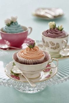 three cupcakes are sitting in tea cups