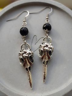 Stunning gothic style raven skull and black obsidian gemstone earrings in silver.  Earwires are made of stainless steel so are hypoallergenic. Skull pendants are made of zinc alloy. Black beads are real obsidian gemstone beads. Sold as a pair.  Please don't hesitate to contact me with any queries or suggestions 😊  Comes gift wrapped 🖤 Jewelry Goth, Crow Skull, Goth Earrings, Raven Skull, Skull Pendant, Skull Earrings, Black Obsidian, Earrings Black, Gothic Style