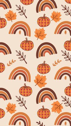 an orange and brown pattern with pumpkins, leaves, and a rainbow in the background