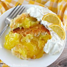 a white plate topped with lemon cobbler and whipped cream