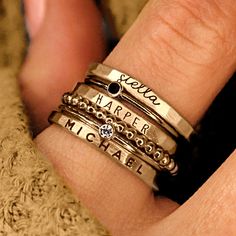 Personalized stackable ring set, engraved with names, dates, or special words. All 6 rings shown in the photos are included in this listing.  Choose between mixed metals, fine silver, or 14K yellow gold-filled for your set! MIXED METALS include: 2 - yellow gold-filled name rings 1 - fine silver name ring 2- sterling silver birthstone rings 1 - yellow gold-filled beaded ring This ring set includes three name rings, a beaded ring, and two cz rings Metal: 14k gold filled, .999 fine silver, .925 ste Stackable Mothers Rings Names, Cool Mothers Rings., Affordable Everyday Stackable Rings With Simple Design, Luxury Engraved Stackable Promise Ring, Cheap Everyday Meaningful Rings, Customizable Cheap Women's Rings, Cheap Bohemian Stackable Rings, Birthstone Ring Mothers Stacked, Stackable Cz Rings