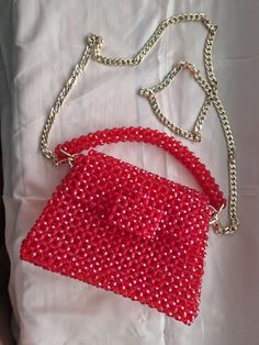 This luxurious beaded evening bag is handmade Bag made of round beads red color. The versatile color will complement any outfit. Bead size 8*6 mm,  Beads are faceted, meaning they are cut with many small flat surfaces that reflect and refract light to create a sparkling, shimmering effect In the work, a fishing line 0.6 mm thick was used The fishing line provides a tight frame. The fishing line can withstand about 10 kg Gold coloured hardware There is a button on the lid. There is a long handle 120 cm , silver colour, material stainless steel The chain can be removed if desired The bag can be carried in hand or over the shoulder. The bag holds a mobile phone, money, cosmetics, keys, wallet The bag is perfect for every day, as well as for a date, a wedding Every girl will be happy with such Red Handheld Shoulder Bag For Party, Red Clutch Shoulder Bag For Party, Handheld Red Shoulder Bag For Parties, Beaded Top Handle Shoulder Bag For Evening, Beaded Crossbody Shoulder Bag For Evening, Handheld Beaded Shoulder Bag For Party, Beaded Top Handle Evening Shoulder Bag, Beaded Evening Shoulder Bag With Top Handle, Red Pouch Shoulder Bag For Party