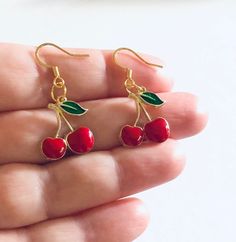 Red cherries earring, drop dangle cherry earrings, Gold plated ear hooks. Cottagecore aesthetic  *GOLD PLATED over STAINLESS STEEL ear hooks  *enamel & gold alloy charms  *earring wires measure approx 0.6" long *charm itself approx just under 0.7" long  *gift box not included  *comes on a jewelry card holder in a clear seal bag Cherry Colored Drop Earrings With Ear Wire, Cherry Dangle Earrings With Ear Wire, Cherry Drop Earrings With Ear Wire, Cherry Color Dangle Earrings, Cute Red Dangle Jewelry, Cherry Colored Earrings For Valentine's Day Gift, Red Cherry Print Jewelry For Gifts, Nickel Free Cherry Colored Earrings For Gift, Cherry Earrings For Valentine's Day Gift