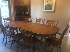 a dining room table with six chairs around it