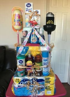 a gift basket with condiments, candy and other items on a table in front of a door