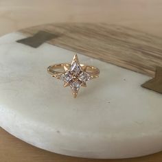 a diamond ring sitting on top of a white marble slab