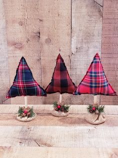 three small plaid christmas trees on top of each other