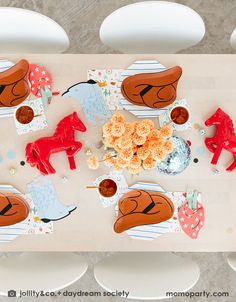 the table is decorated with paper animals and other decorations