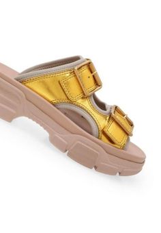 These Gucci leather sandals make a casual essential that's elevated with an outdoor-inspired vibe. This slide-sandal hybrid is designed with metallic double leather straps, a technical canvas lining, and a chunky, oversized rubber sole.Open toeBuckle fasteningChunky heel.Composition: Calf Leather 100%, Polyamide 100%Lining: Polyamide 100%, Polyurethane 100%Sole: Rubber 100%Made in Italy Gucci Sandals With Buckle Closure And Open Toe, Gucci Open Toe Sandals With Buckle Closure, Luxury Summer Slides With Buckle Closure, Designer Summer Slides With Buckle Closure, Leather Chunky Platform Open Toe Slides, Casual Gold Slides With Buckle Closure, Modern Slide Sandals For Streetwear, Luxury Leather Platform Slides, Gucci Sandals With Buckle Closure For Summer