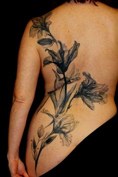 a woman's back with flowers on it