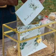 a glass box with some cards in it that say thank you on the front and side