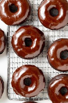 chocolate donuts on a cooling rack ready to be baked in the oven for consumption