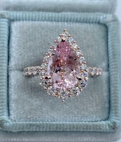 Gorgeous Pear Morganite Diamond Ring Rose Gold. Calling all pear lovers, this ring is simply stunning! The halo of diamonds frames this beautiful morganite gem perfectly. The diamonds are very sparkling, set with graduated sizes. Excellent craftsmanship, all diamonds are set smooth. You see sparkles from every angle, even the prongs have diamonds set. Very comfortable ring to wear, the band doesn't feel bulky. This ring has the wow factor. This is my best quality morganite. The diamonds are clea Luxury Gia Certified Pear-shaped Wedding Ring, Pear-shaped Diamond Ring With Gemstone, Gia Certified Pear-shaped Cubic Zirconia Ring, Pear Shaped Rose Cut Diamond Ring For Proposal, Pear-shaped Rose Cut Diamond Rings For Proposal, Pear-shaped Rose Cut Diamond Proposal Ring, Pear-shaped Pink Diamond Jewelry, Pear-shaped Morganite Jewelry, Pink Pear Engagement Ring