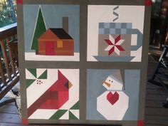 four different quilts are displayed on a porch