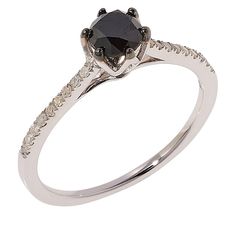 a black diamond ring with white diamonds on the band and an oval shaped center stone