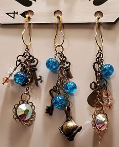 three pairs of key charms hanging from hooks