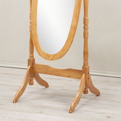 a wooden stand with a large mirror on it's top and legs in the middle