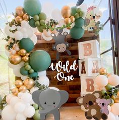 an animal themed birthday party with balloons and decorations