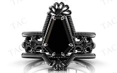 a black stone ring with intricate filigrees