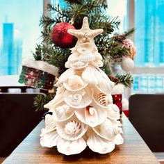 a christmas tree made out of seashells on a table