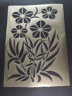 a metal plate with some flowers on it