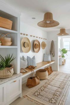 a room with many hats hanging on the wall and some baskets in front of it