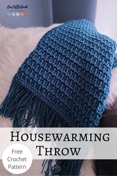 a blue crochet scarf with text that reads housewarming throw