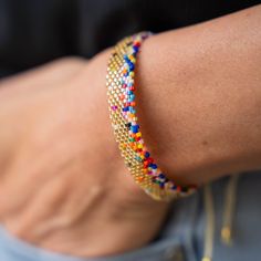 a close up of a person's arm wearing a bracelet with beads on it