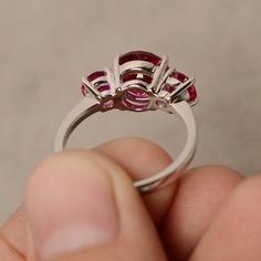 This is a gorgeous handmade creation. Its beauty is its simplicity & Elegance. The 8 mm round cut faceted lab ruby and two 5mm lab ruby is crafted in solid sterling silver and with rhodium plated. All item is sent in a beautiful gift box You can realize more lovely stuff clicking the link https://www.etsy.com/shop/knightjewelry?refshopsection_shophome_leftnav Please leave the correct address and you phone number for delivering successfully. Antique Ruby Ring, Star Ruby Ring, Original Jewelry Design, Sterling Silver Promise Rings, Zircon Ring, Wedding Bridal Jewellery, Ruby Ring, Three Stone Rings, Multi Stone Ring