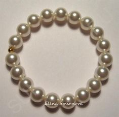 a bracelet with white pearls on it