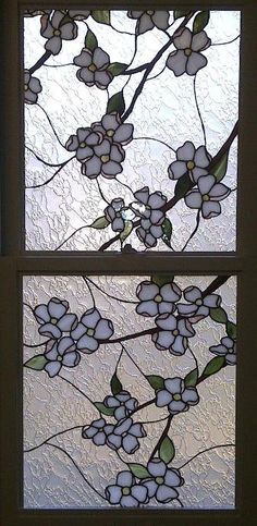 two stained glass windows with white flowers on them