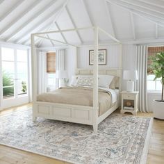 a white bed sitting on top of a wooden floor