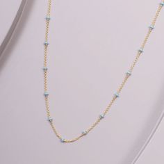 This meticulously crafted necklace is made with 14-karat gold and adorned with gentle, blue enamel accents. A sublime addition to any outfit, it brings a perfect touch of color and sophistication to your ensemble. Gold Enamel Necklace With Delicate Chain, Elegant Blue Jewelry With Beaded Chain, Elegant Blue Beaded Chain Jewelry, Blue Pendant Necklace With Cable Chain, Light Blue Beaded Chain Jewelry Gift, Elegant Light Blue Necklace With Beaded Chain, Elegant Light Blue Beaded Chain Necklaces, Elegant Light Blue Beaded Chain Necklace, Gold Enamel Necklace With Cable Chain