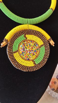 African Pendant Necklace, African Pendant Jewelry, African Beaded Necklace, Zulu Beaded Necklace, Gift For Her This stunning pendant necklace is superbly crafted which makes you stands out in any occasion. Main Color - Yellow and Green. Different colors of your choice can be available. Wholesale available at a fair price. For any query please send me a convo or an e-mail. Happy Shopping Yellow Beaded Bib Necklaces With Round Beads, Multicolor Beaded Necklaces With Large Round Pendants, Multicolor Large Beaded Round Pendant Necklace, Unique Beaded Necklaces With Gold Beads, Unique Beaded Necklace With Gold Beads, Unique Gold Beaded Necklaces With Round Beads, Colorful Beaded Necklaces In Yellow, Yellow Beaded Pendant Necklace, Wholesale Necklaces