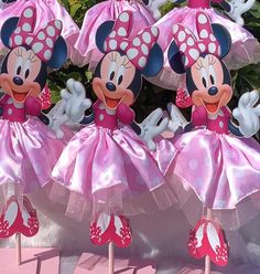 three minnie mouse figurines in pink tutu skirts