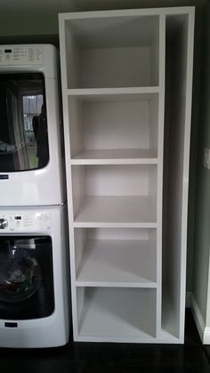 a washer and dryer sitting next to each other in front of a white bookcase