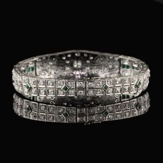 Stunning antique platinum bracelet with old european cut diamonds and emeralds. Item #B0024 Metal: Platinum Weight: 29.3 Grams Total Diamond Weight: Approximately 5.50 cts Diamond Color: H Diamond Clarity: VS2 - SI1 Measurements: 7 in x 5.5 mm Layaway: For your convenience, we will be happy to provide layaway payment options. Please contact us to work out a layaway plan which best suits your needs. All layaway purchases are final sale. All domestic and international shipments are shipped with Fe Luxury Silver Tennis Bracelet With Emeralds, Formal Silver Tennis Bracelet With Emeralds, Formal Silver Emerald Tennis Bracelet, Silver Emerald Tennis Bracelet For Formal Occasions, Art Deco Diamond Bangle Bracelet For Wedding, Formal Emerald Diamond Bracelet With Brilliant Cut, Formal Silver Diamond Bracelet With Emeralds, Formal Emerald Diamond Bracelet, Wedding Art Deco Diamond Bangle Bracelet