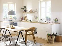 the kitchen is clean and ready to be used for cooking or dining, with plants in pots on the counter