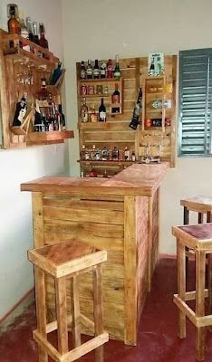 the bar is made out of wood and has two stools in front of it