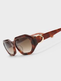 Featuring a classy tortoiseshell design, geometric lenses and a sleek silhouette, these Gabine sunglasses are the accessory you should be adding to your collection right now. The functional and chic tinted lenses add to the vintage allure that complements the overall aesthetic, while offering protection from harmful UV rays. The little Gabine buckles on the sides add a sophisticated touch of shine. Charles Keith, Design Geometric, Oval Sunglasses, Sunglasses & Glasses, Uv Rays, Tortoise Shell, The Vintage, Right Now, Lenses