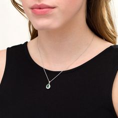 Perfect your evening attire with this tasteful fashion pendant. Fashioned in sterling silver, this regal look showcases a 7.0 x 5.0mm pear-shaped lab-created verdant-green emerald wrapped in a shimmering lab-created white sapphire-touched shadow-style frame. Buffed to a brilliant luster, this pendant suspends along an 18.0-inch rope chain that secures with a spring-ring clasp. Formal Pear Shaped Necklace With May Birthstone, Formal Pear-shaped May Birthstone Necklace, Formal Pear Shaped Necklace For May Birthstone, Elegant Teardrop Birthstone Drop Necklace, Pear-shaped Drop Necklace For Formal Occasions, Elegant Pear-shaped Birthstone Drop Necklace, Formal Teardrop Necklace With May Birthstone, Formal Teardrop Necklace For May Birthstone, Elegant Oval Pendant Gemstone Drop Necklace