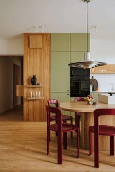 a kitchen with a table, chairs and an oven in the back ground is shown