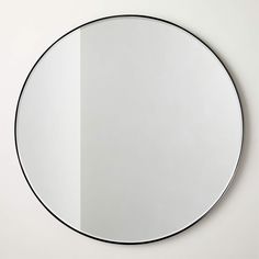 a round mirror is hanging on the wall