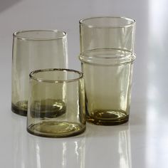 three glasses sitting next to each other on a table